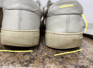 The heel of the shoe is worn unevenly
