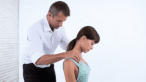 Male chiropractor assessing cervical region of a female patient at Knigs Park Chiropractic